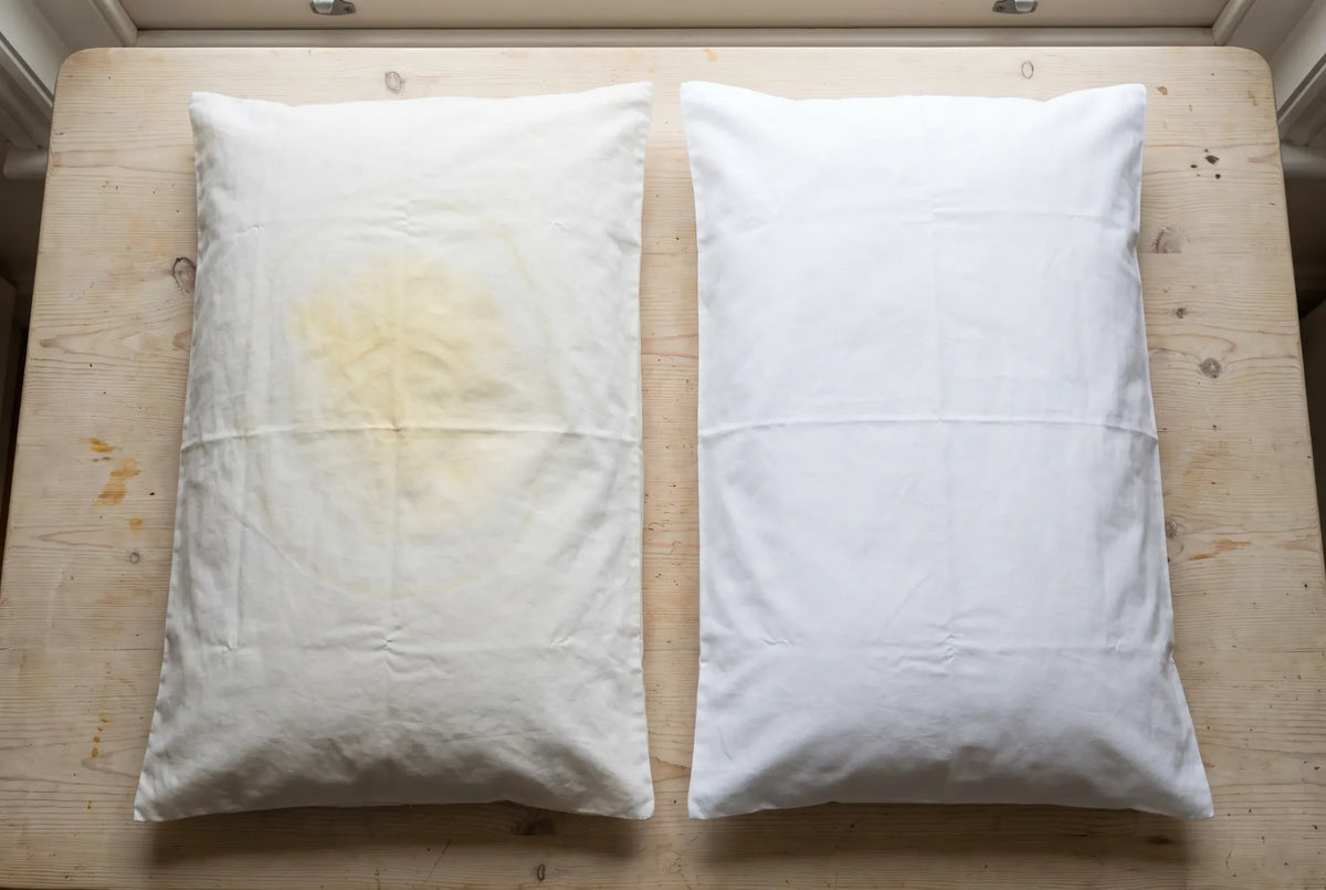 A yellowed pillowcase next to a clean white one