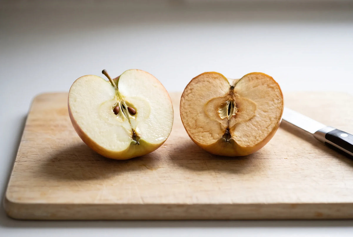 A fresh apple half beside one that has turned brown in the air